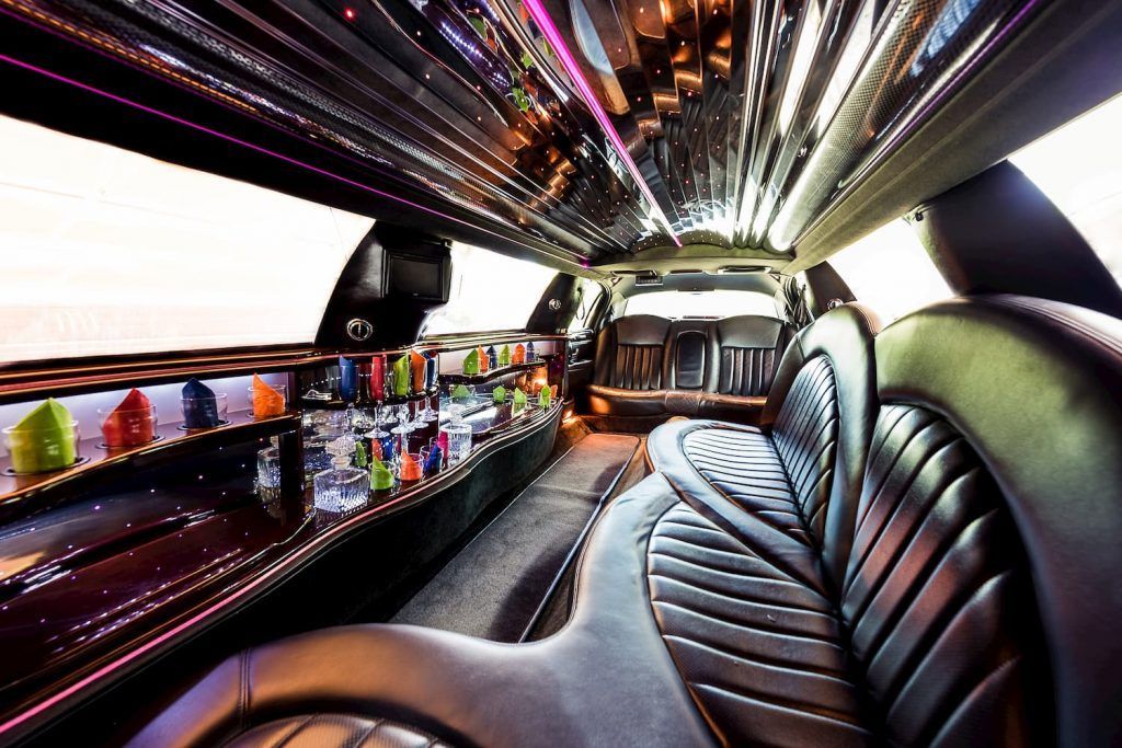 The inside of a limousine with a bar in the back.