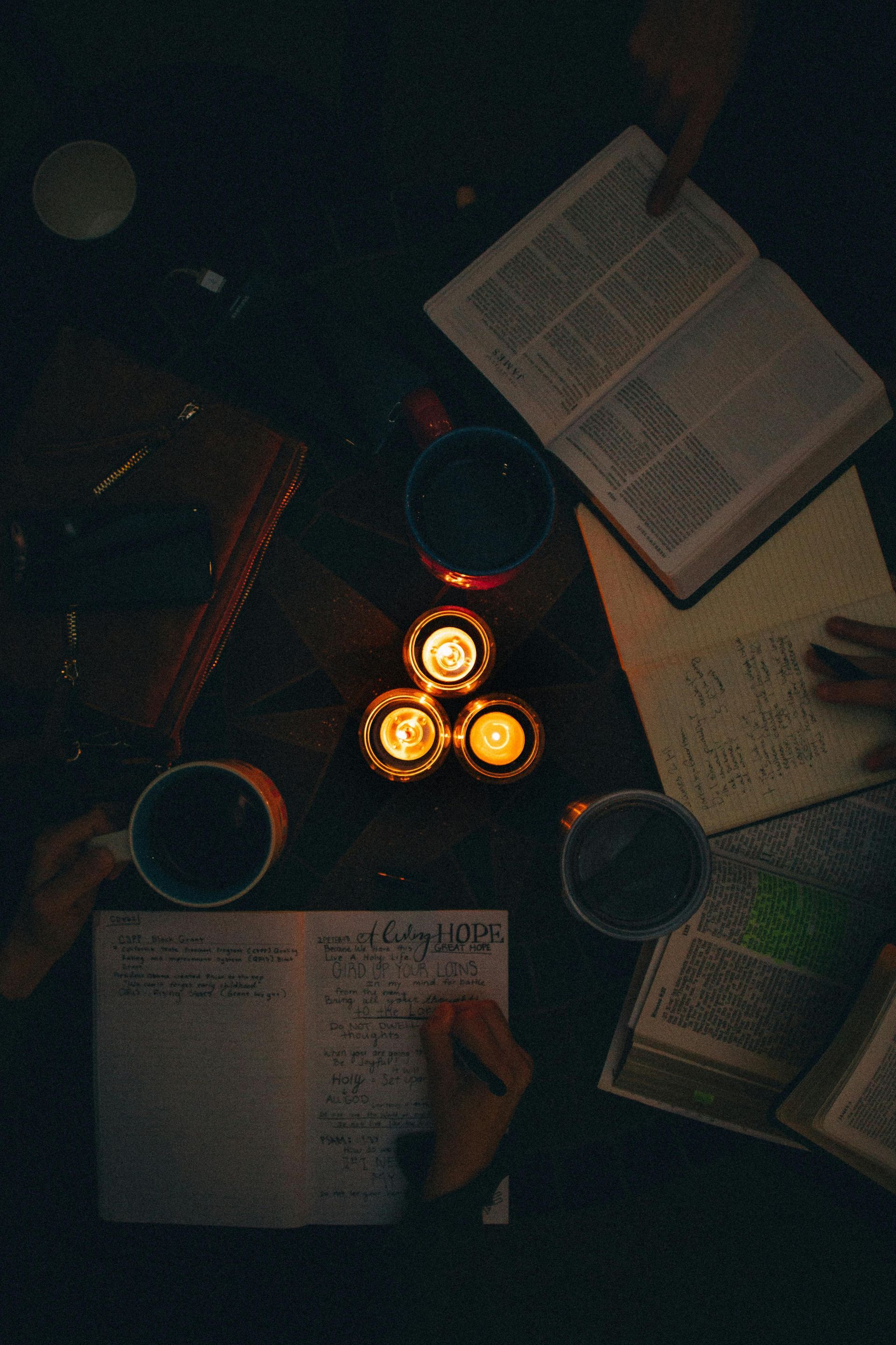 photo of a Bible with coffee cups around it