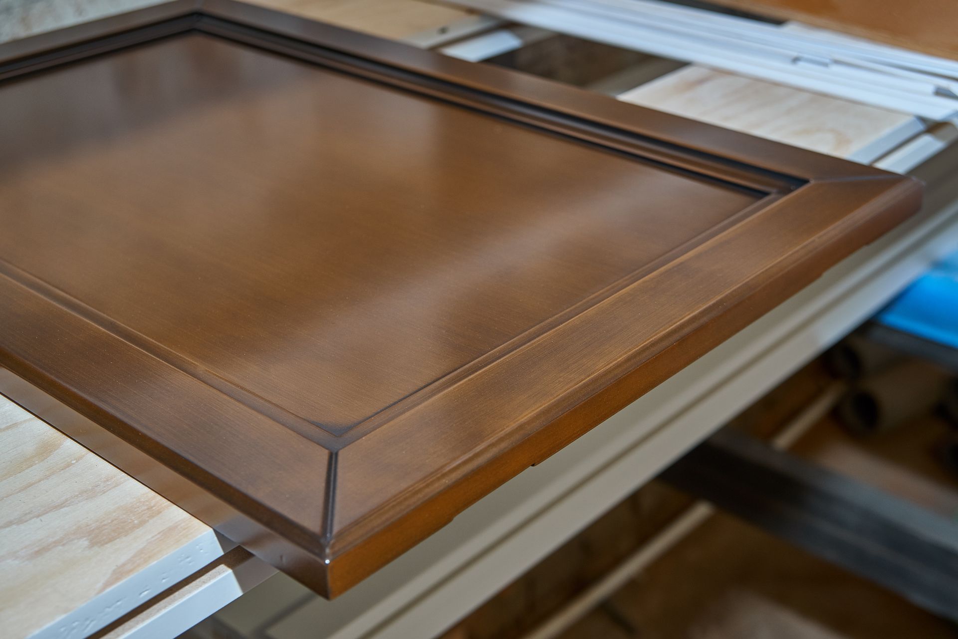 A wooden frame is sitting on top of a wooden table.