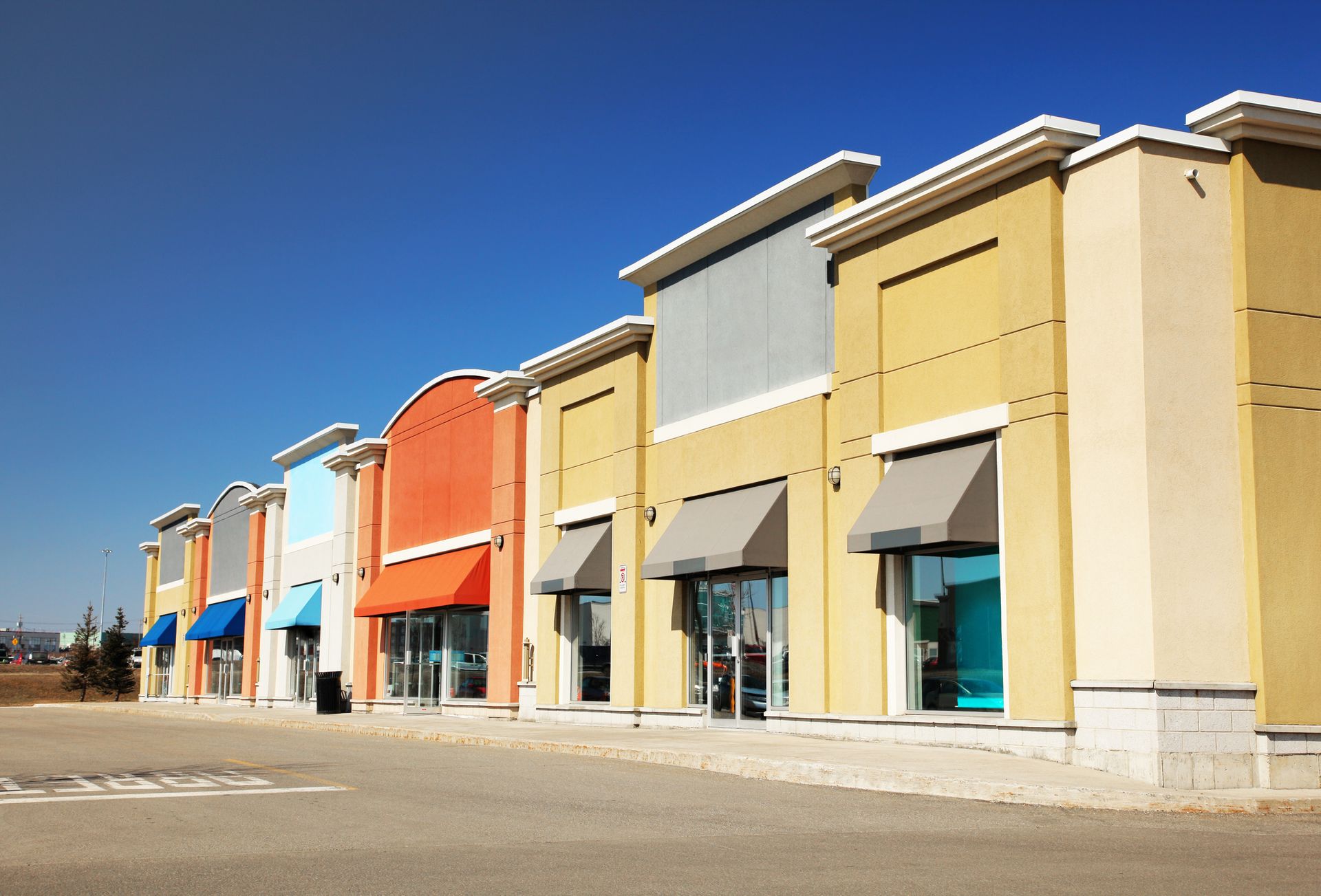 A row of colorful buildings with awnings on the windows