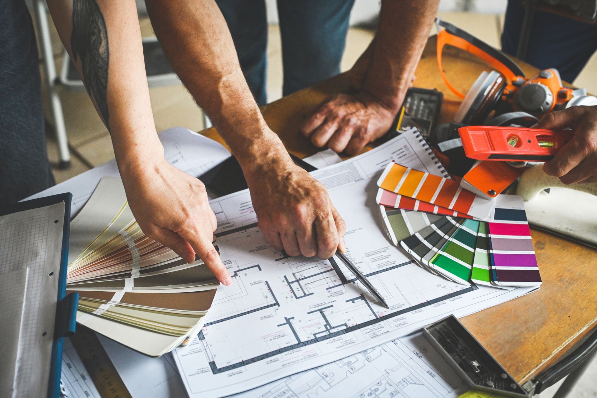 A group of people are looking at a floor plan of a house.