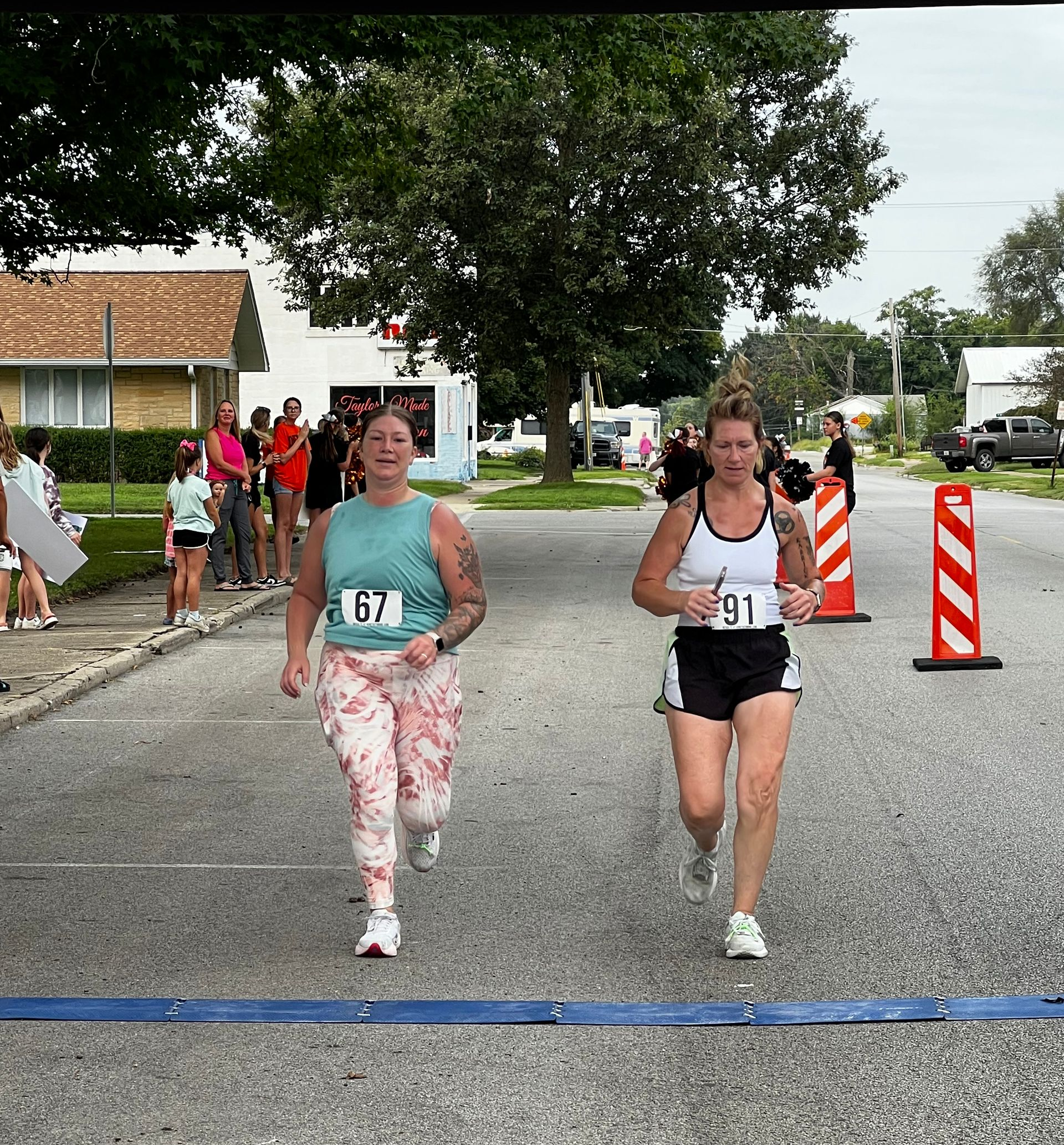 A group of people are running down a road.