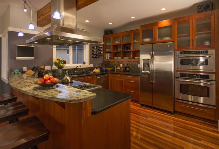 Modern kitchen with wood cabinets, stainless steel appliances, and granite countertops.