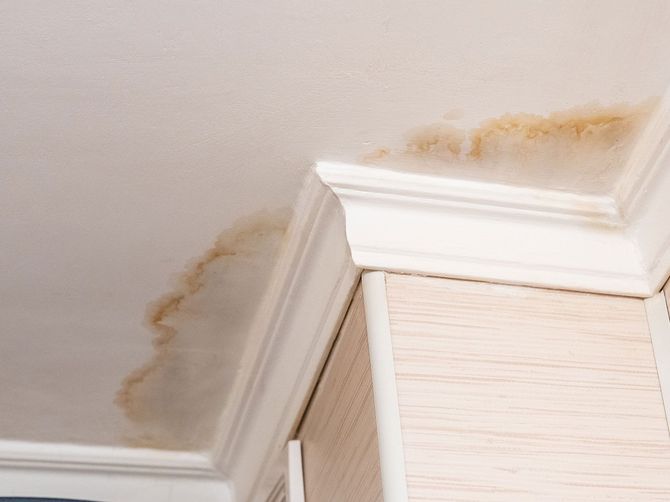 Neighbors have a water leak, water-damaged ceiling, close-up of a stain on the ceiling