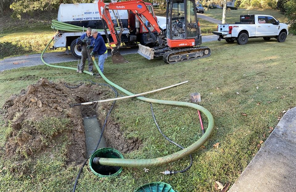 A man is pumping water into a septic tank.