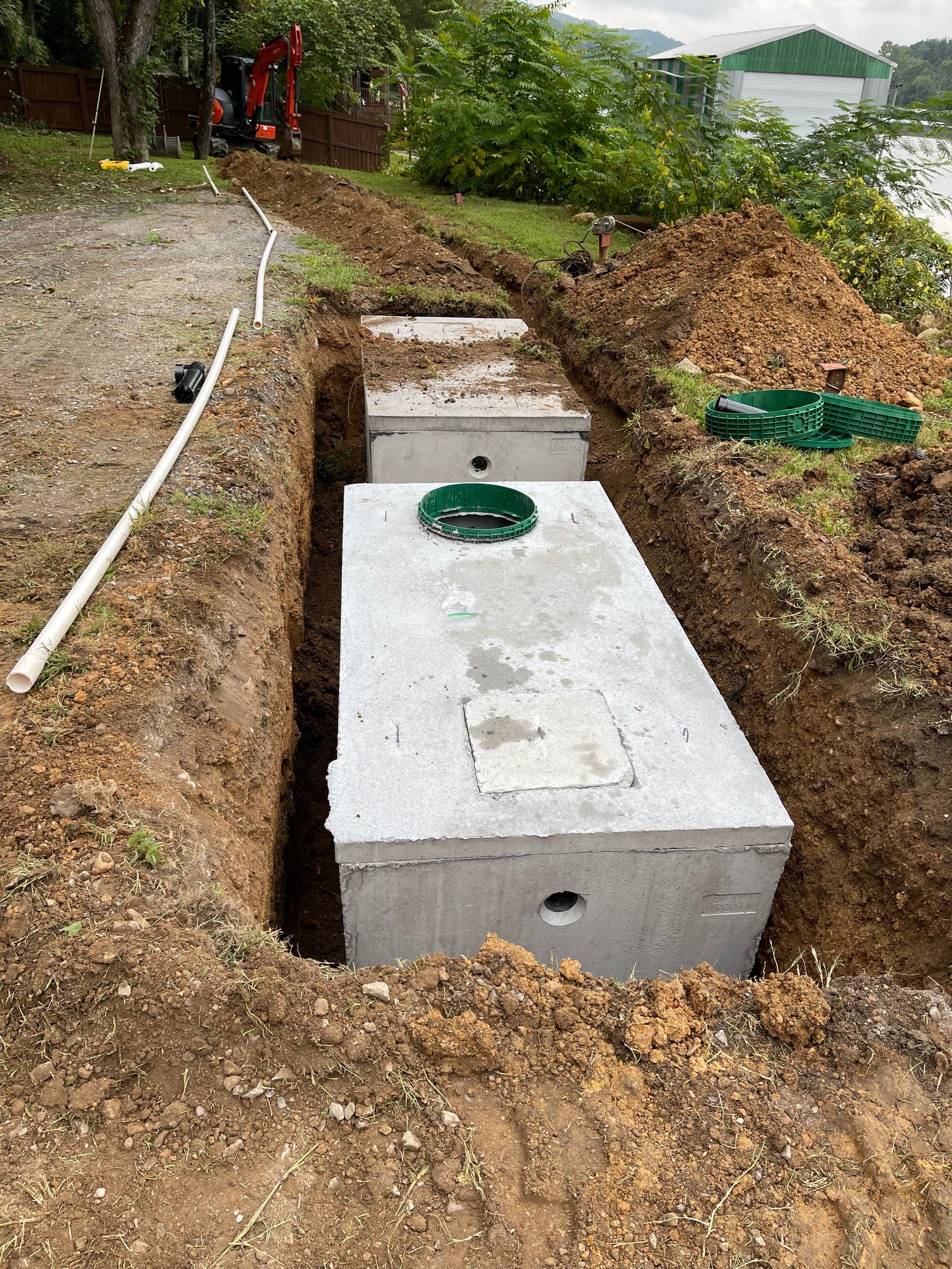 A septic tank is being installed in a hole in the ground.