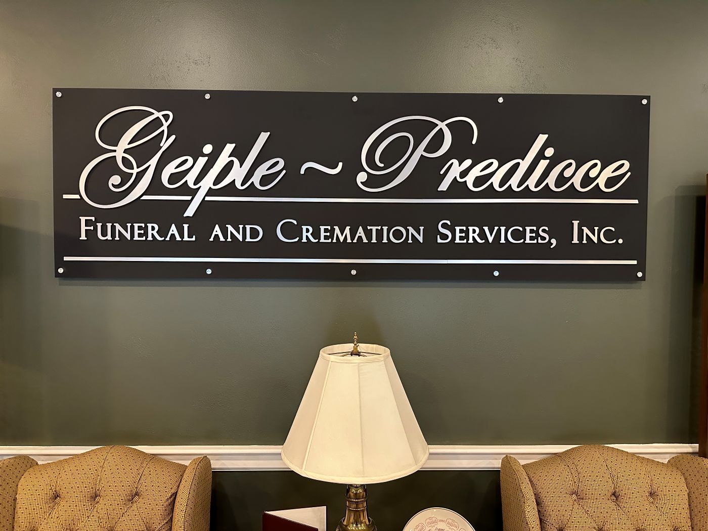 A sign on a wall that says geiple predicce funeral and cremation services inc.