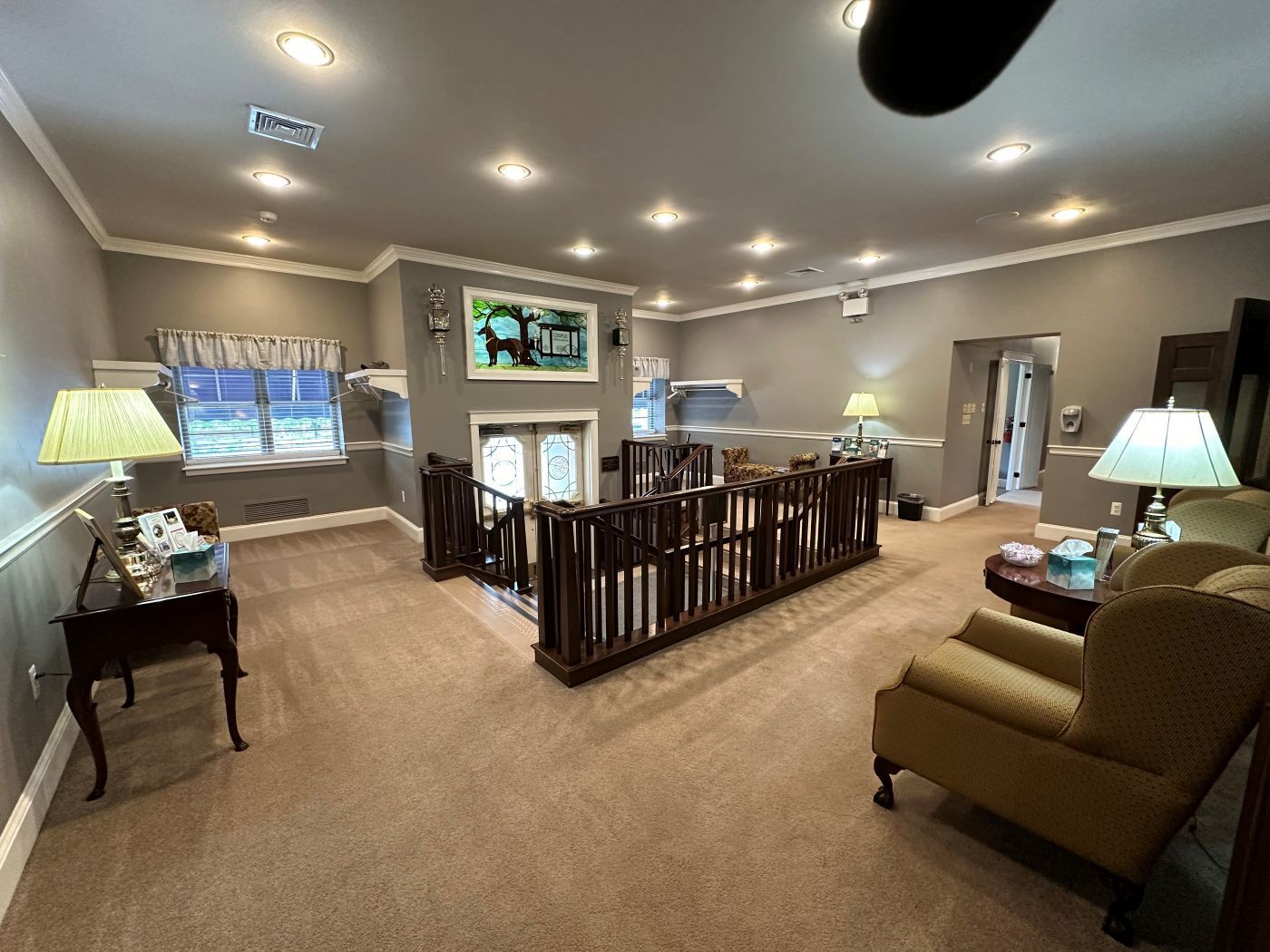 A living room with a staircase leading up to the second floor.