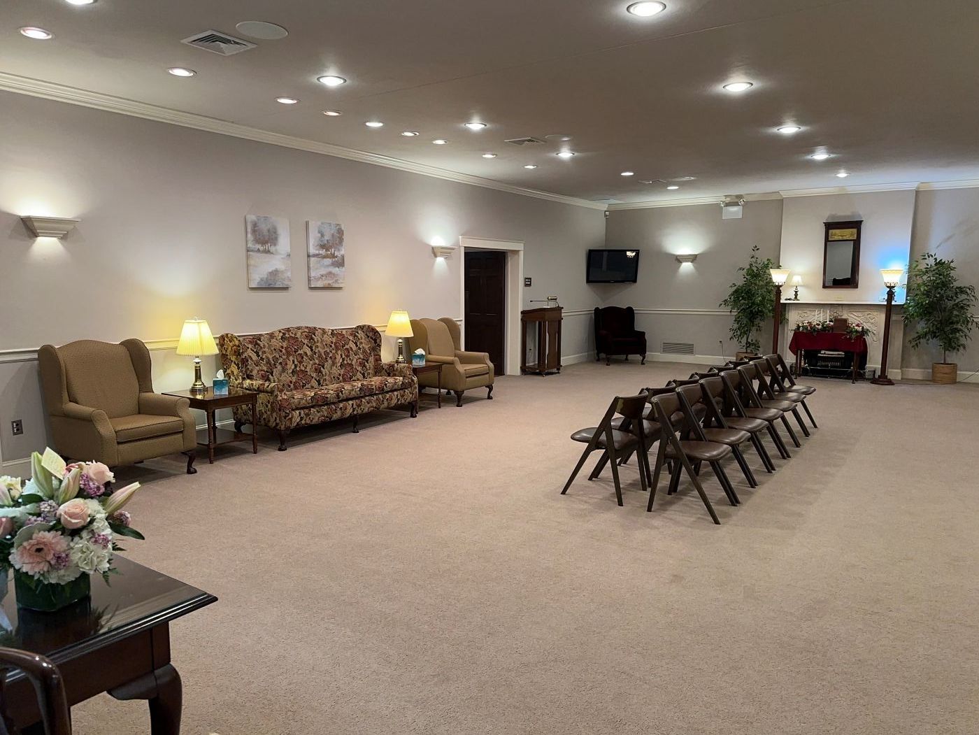 A large room with a couch and chairs in it.