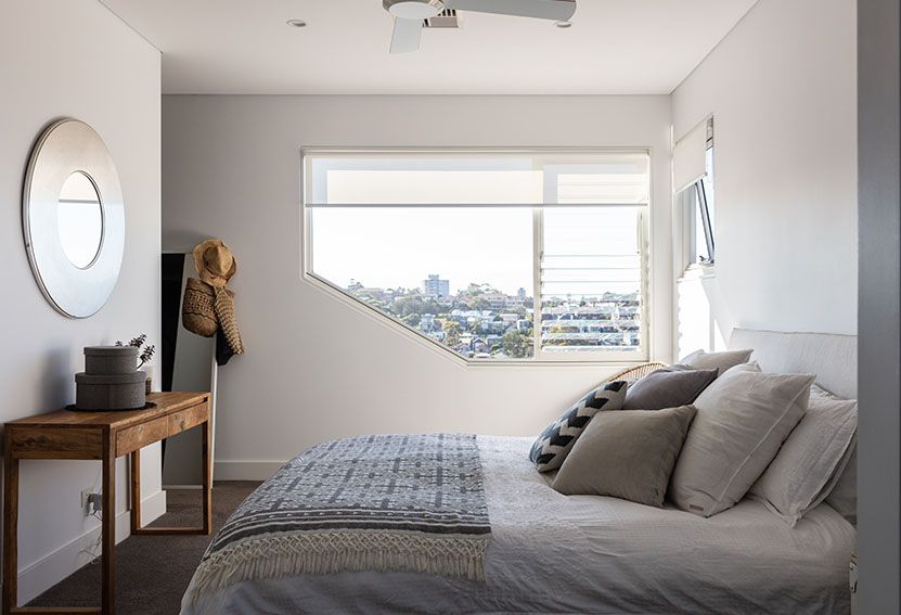 Bedroom With Bed, Window, and Small Wooden Table; Neutral Colors, Sunlight — Burmah Constructions In Kangaroo Valley, NSW