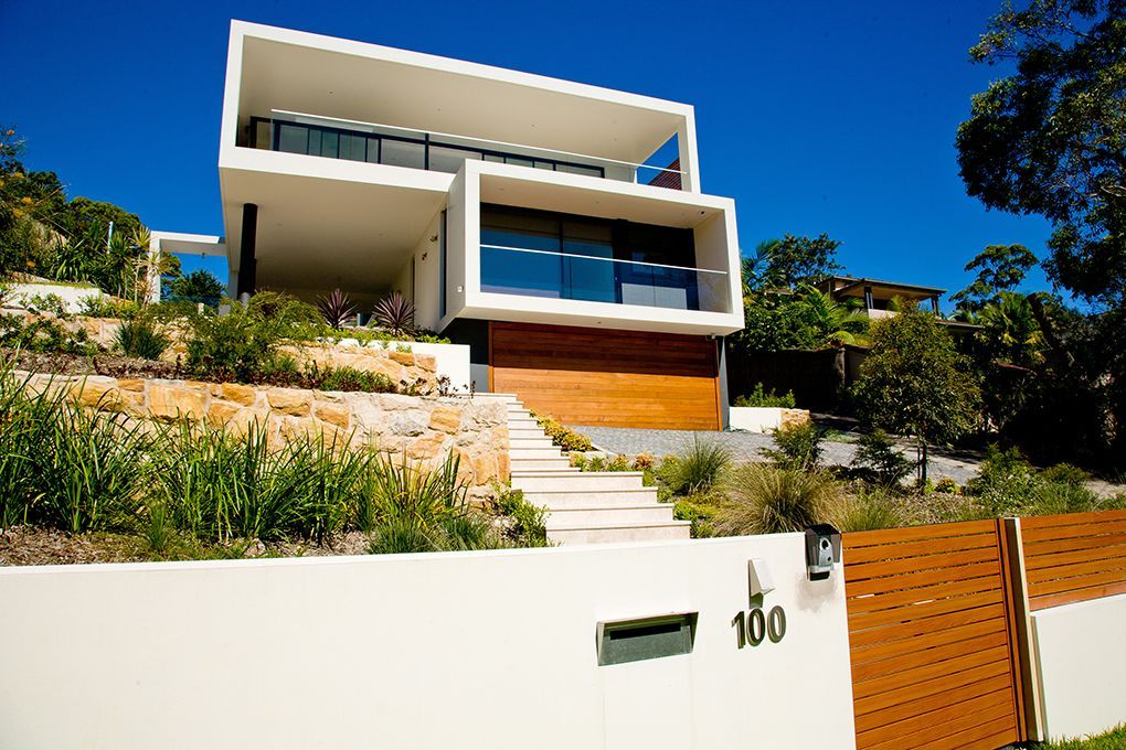 Modern White House With Flat Roof and Wood Garage Door — Burmah Constructions In Kangaroo Valley, NSW