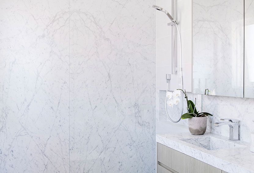 White Marble Bathroom With Shower, Vanity, and Potted Plant — Burmah Constructions In Kangaroo Valley, NSW