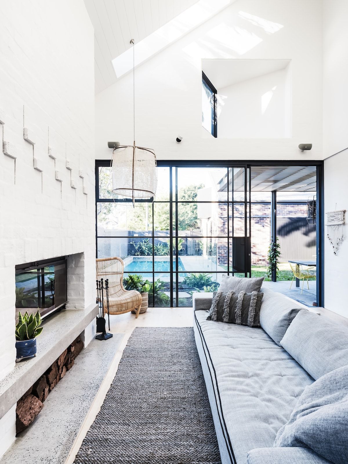 Modern Living Room With a Fireplace, Gray Sofa, and Large Glass Doors — Burmah Constructions In Kangaroo Valley, NSW
