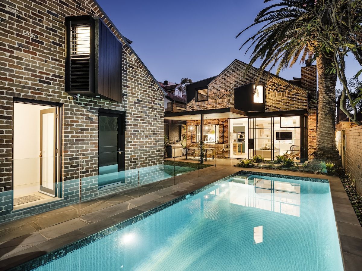 Backyard With Pool; Brick House With Open Doors, Shutters — Burmah Constructions In Kangaroo Valley, NSW