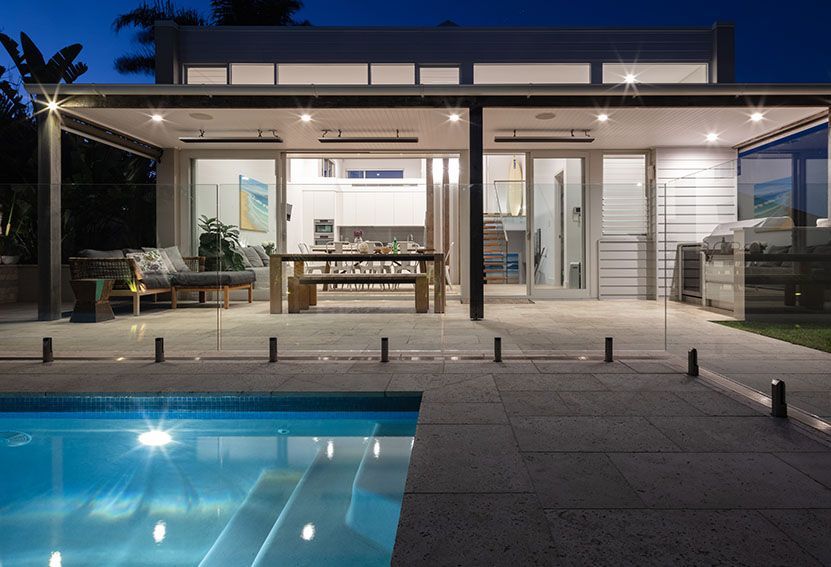 Poolside Outdoor Area at Night With a Covered Patio — Burmah Constructions In Kangaroo Valley, NSW