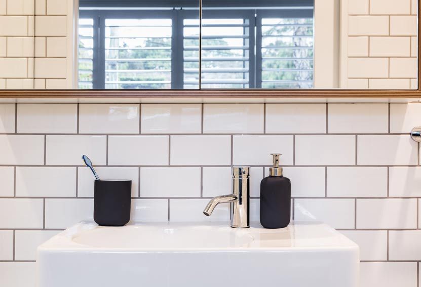 White Bathroom Sink With Faucet, Black Soap Dispenser — Burmah Constructions In Kangaroo Valley, NSW