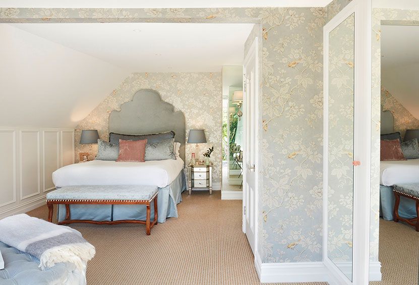 Bedroom With a Bed, Bench, and Floral Wallpaper — Burmah Constructions In Kangaroo Valley, NSW