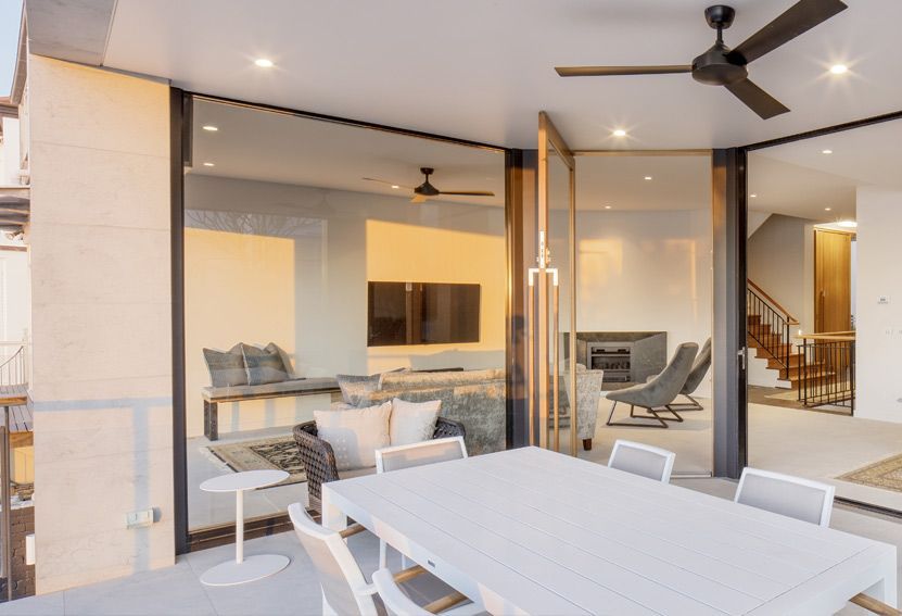 Patio With Glass Doors Open to Living Room. White Dining Table — Burmah Constructions In Kangaroo Valley, NSW