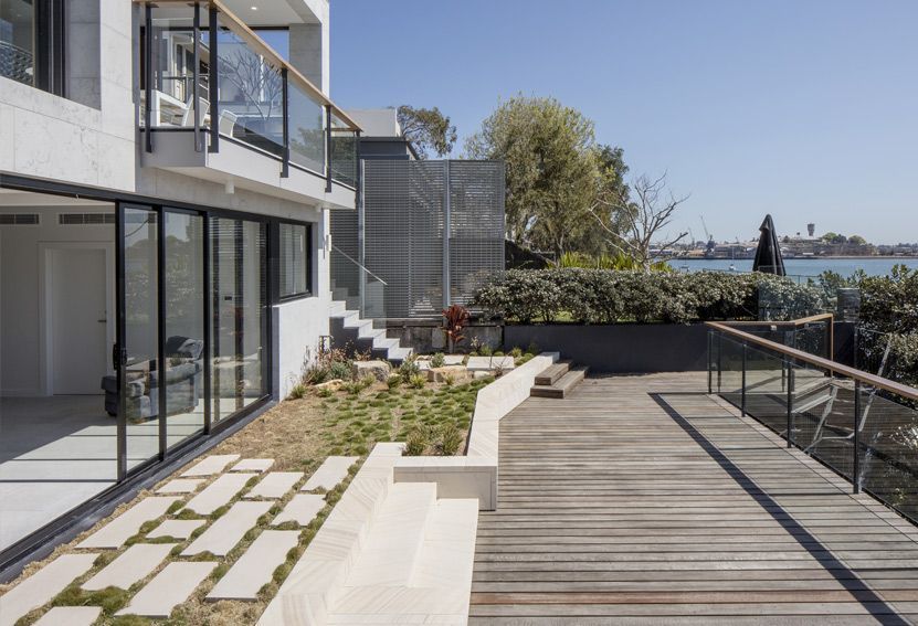 Coastal House Exterior With Deck and Glass Railings Overlooking the Water — Burmah Constructions In Kangaroo Valley, NSW
