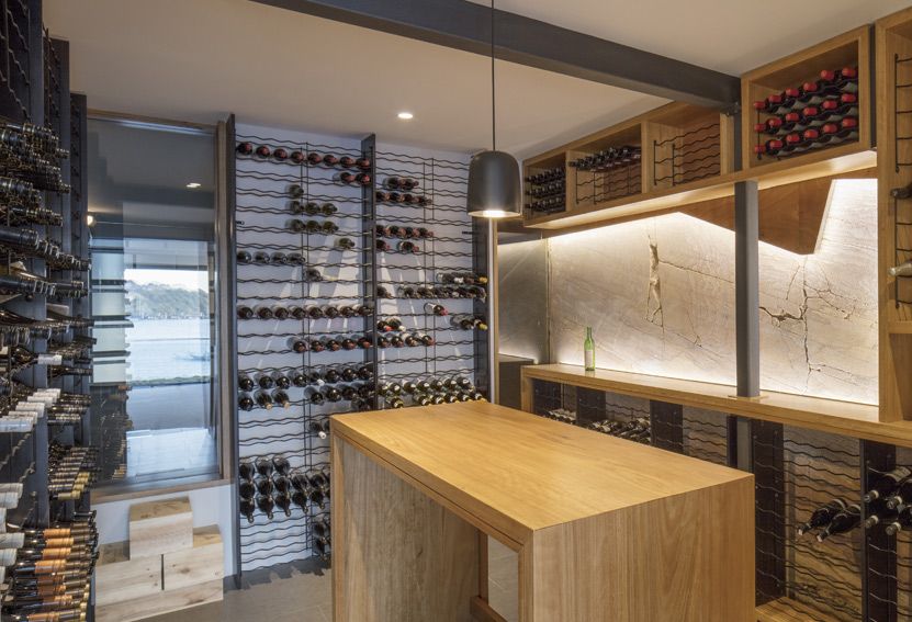 Wine Cellar With Wooden Racks, a Tasting Table, and Modern Lighting — Burmah Constructions In Kangaroo Valley, NSW