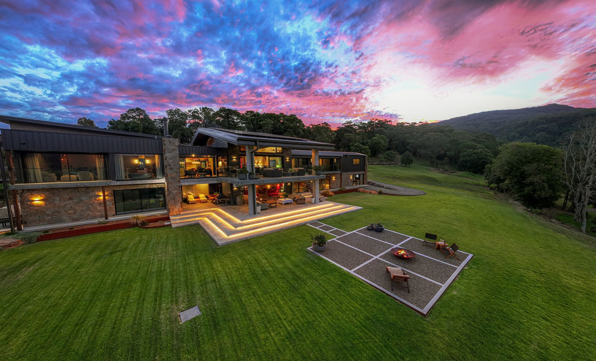 Hillside House With Glowing Balconies, Green Lawn, and a Sunset Sky — Burmah Constructions In Kangaroo Valley, NSW