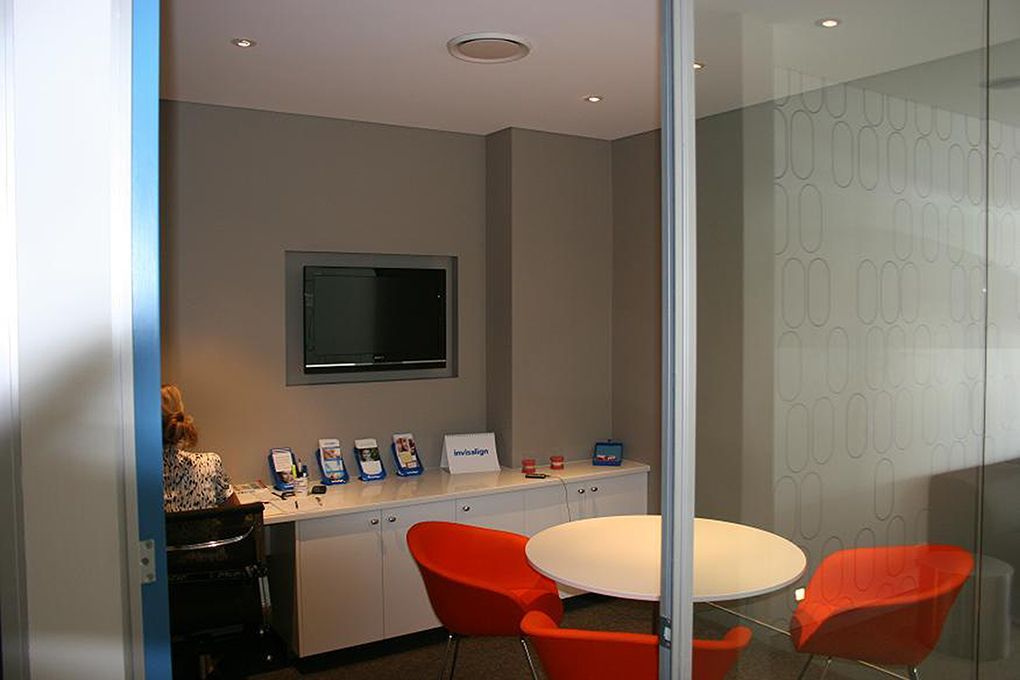 Small Office Space With a Round Table and Orange Chairs — Burmah Constructions In Kangaroo Valley, NSW