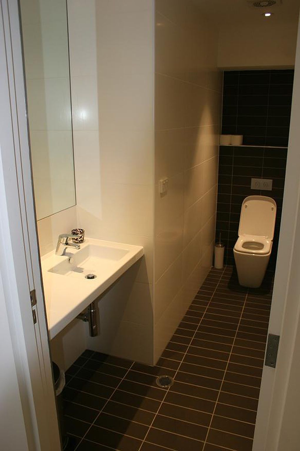 Bathroom With White Walls and Sink, Dark Tiled Floor and Toilet — Burmah Constructions In Kangaroo Valley, NSW