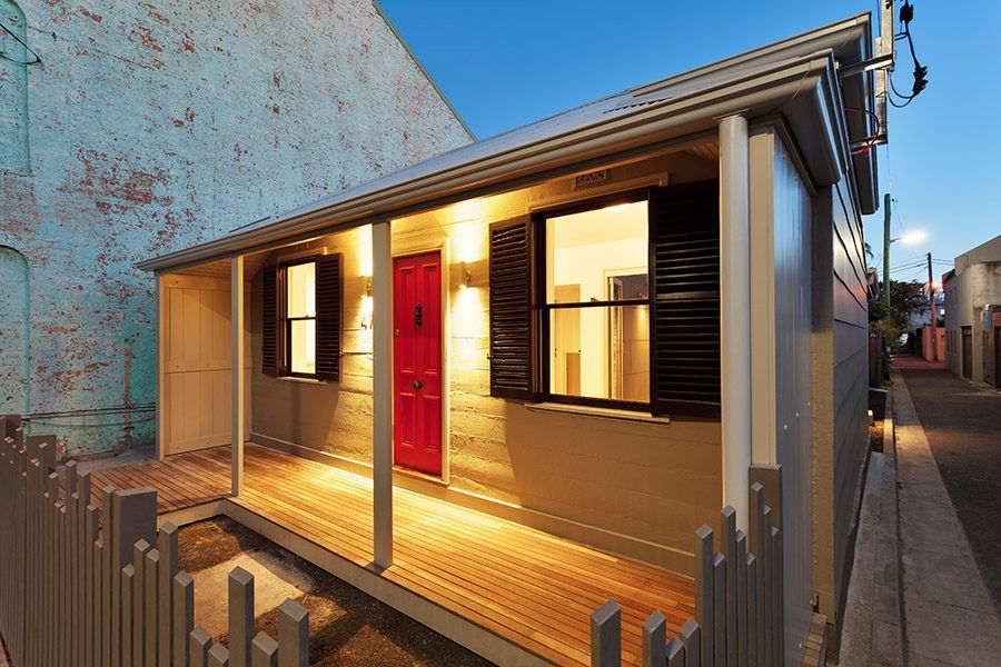 Small Cottage With Red Door, Wooden Porch, and Black Shutters — Burmah Constructions In Kangaroo Valley, NSW