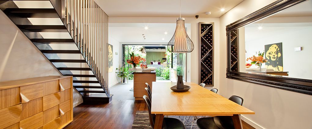 Modern Dining Room With a Wooden Table, Stairs, and a Large Mirror — Burmah Constructions In Kangaroo Valley, NSW