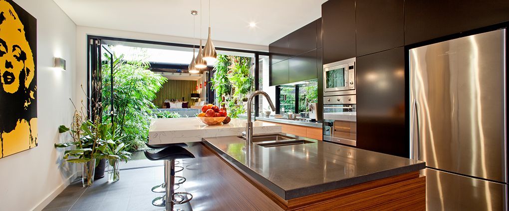 Modern Kitchen With a Gray Countertop Island, Stainless Steel Refrigerator — Burmah Constructions In Kangaroo Valley, NSW