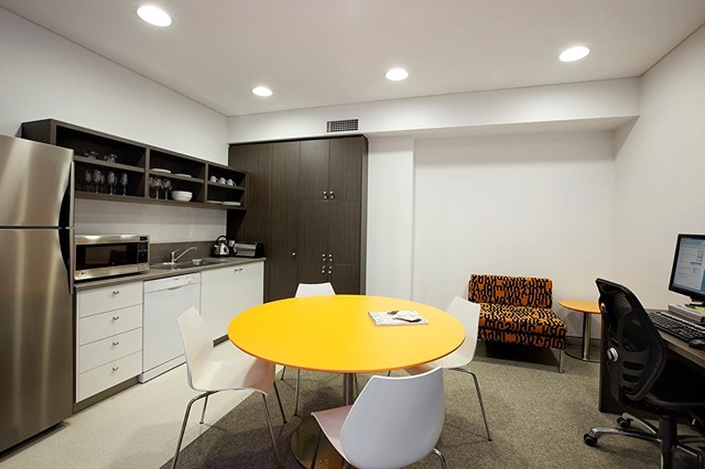 Office Kitchen With a Yellow Table, Small Sofa, and Computer — Burmah Constructions In Kangaroo Valley, NSW