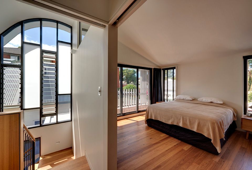 Bedroom With Large Windows, Balcony, and Hardwood Floors — Burmah Constructions In Kangaroo Valley, NSW