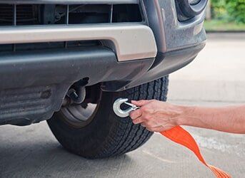 Man Towing a Car — Tires & Auto Repairs in San Antonio, TX