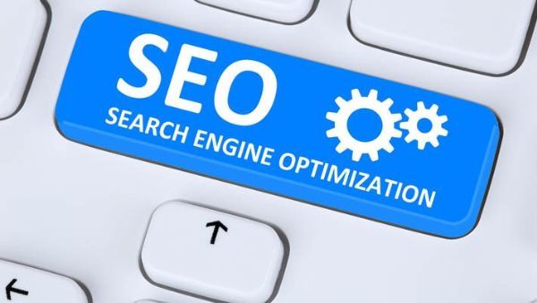 A blue button on a keyboard that says SEO search engine optimization