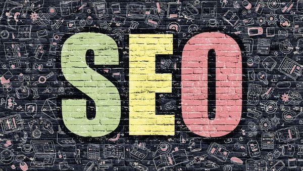 The word seo is painted on a brick wall .