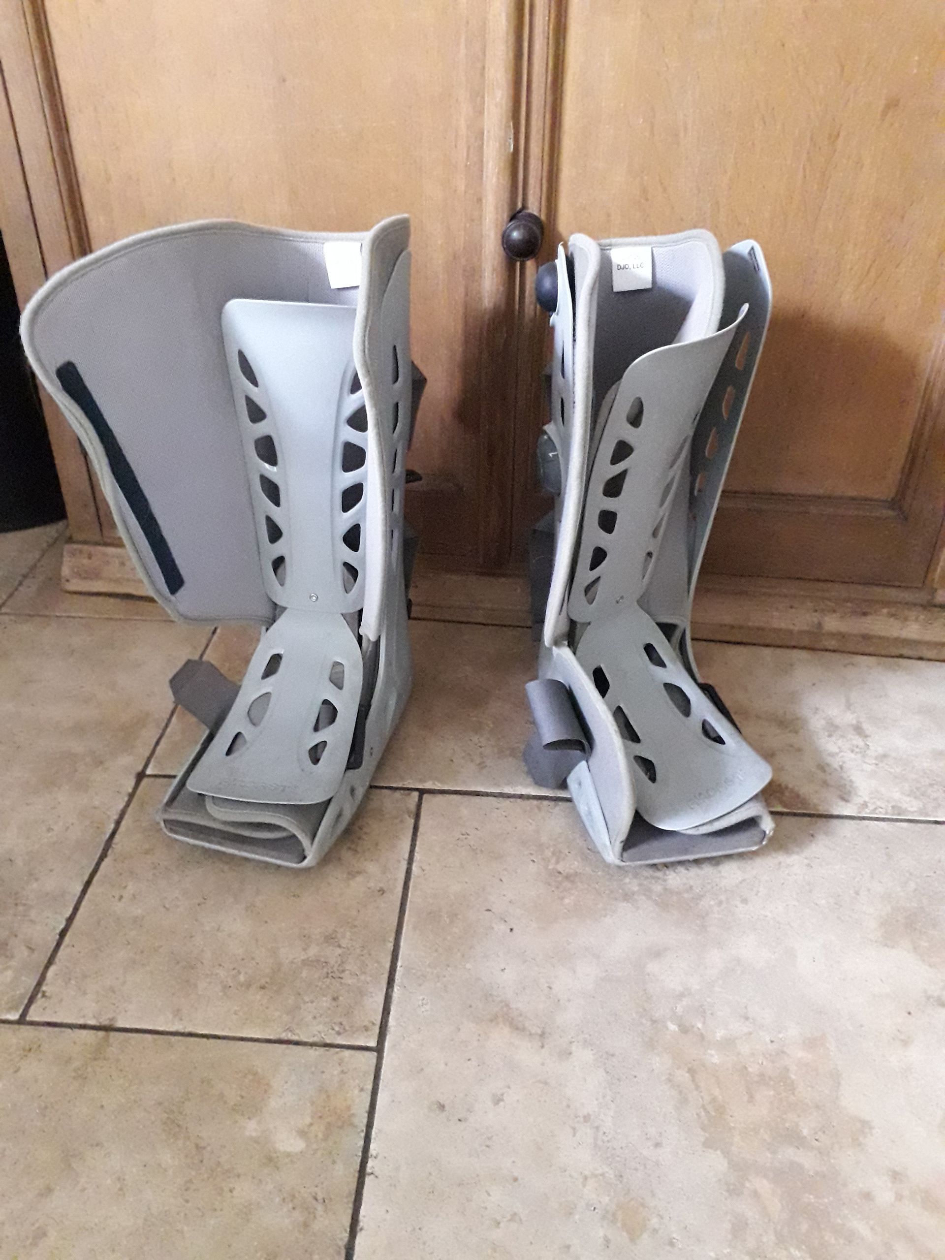 Fracture boots worn to help mend two broken ankles.