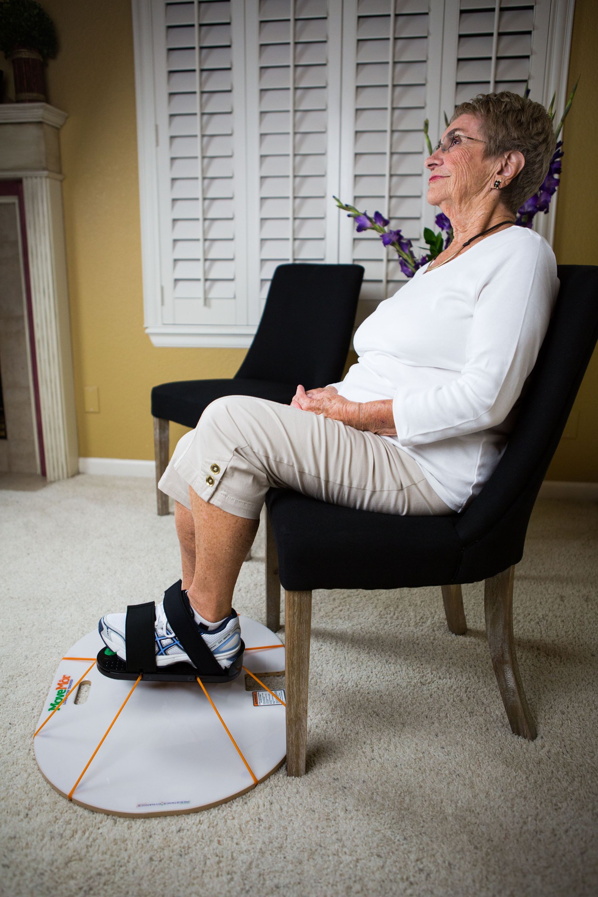 a woman is sitting in a chair with a cast on her foot .