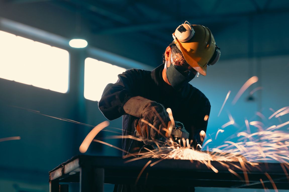 Grinding a Piece of Metal in A Factory — Madisonville, KY — Wil-Mar Hydraulics & Machine Inc.