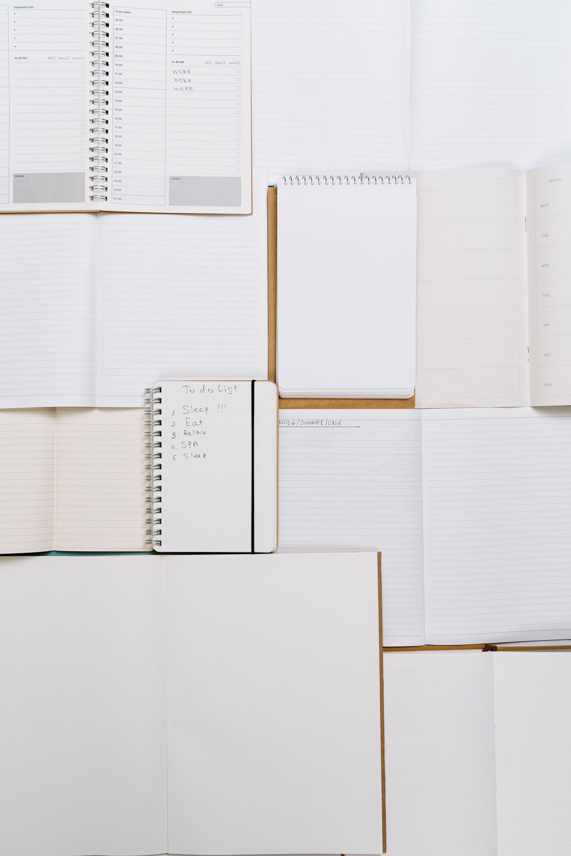 Open blank notebook pages arranged in a grid on a white background