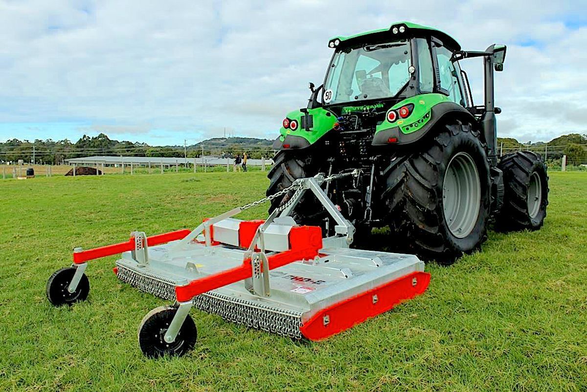 A Tractor Is Spraying a Field with A Sprayer Attached to It — Thompson's Farm Gear In Port Macquarie, NSW
