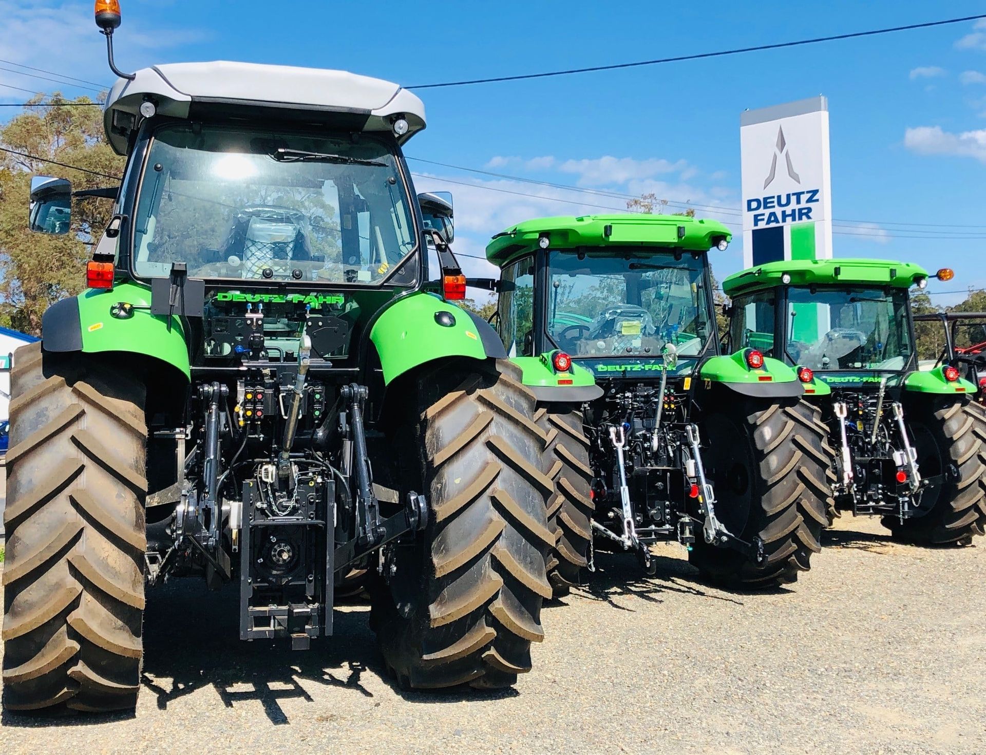 Springtime Tractor Spraying Pesticides on Corn Field with Sprayer — Thompson's Farm Gear In Kempsey, NSW