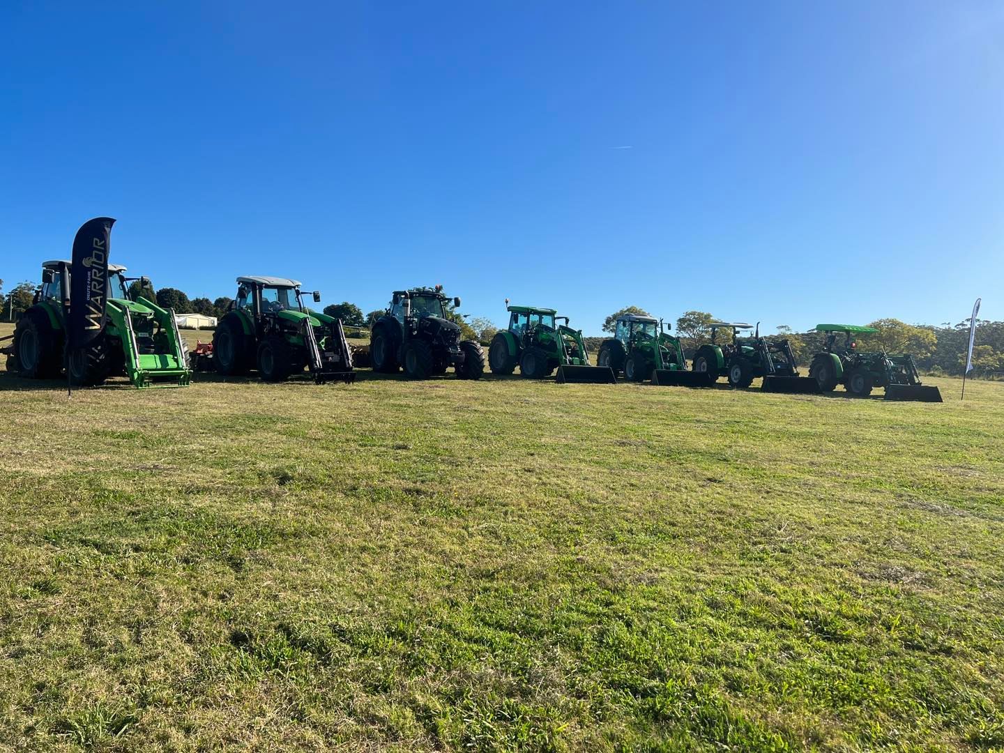 A Red Tractor Is Plowing a Field with A Plow — Thompson's Farm Gear In Wingham, NSW