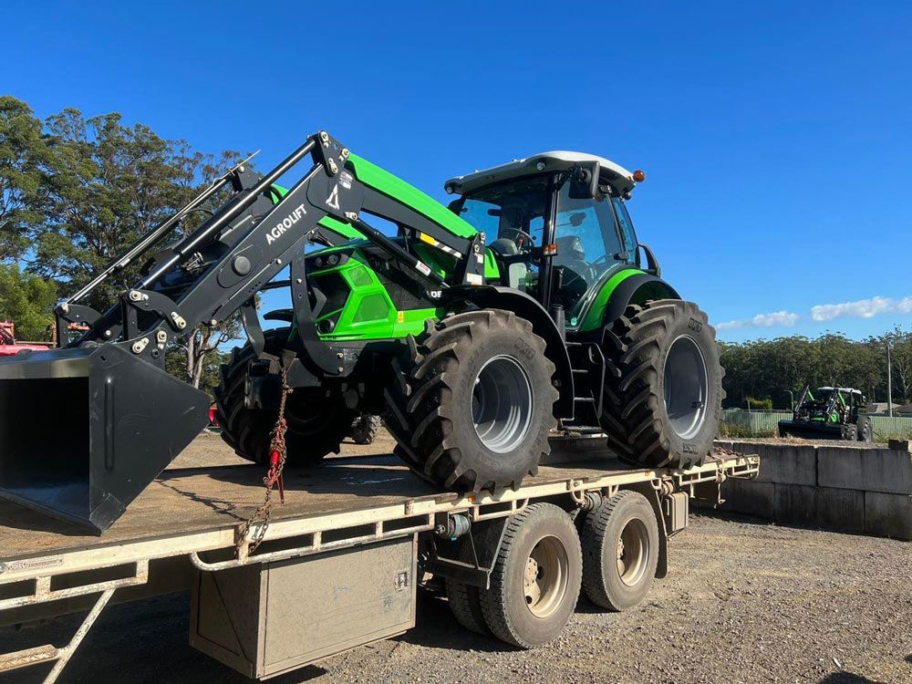 Deutz Fahr Tractor with Agrolift Loading on Flatbed Truck — Thompson's Farm Gear In Wingham, NSW