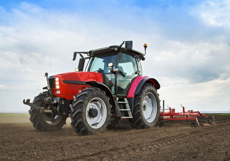Farmer in Tractor Preparing Land for Sowing Seeds — Thompson's Farm Gear In Wauchope, NSW