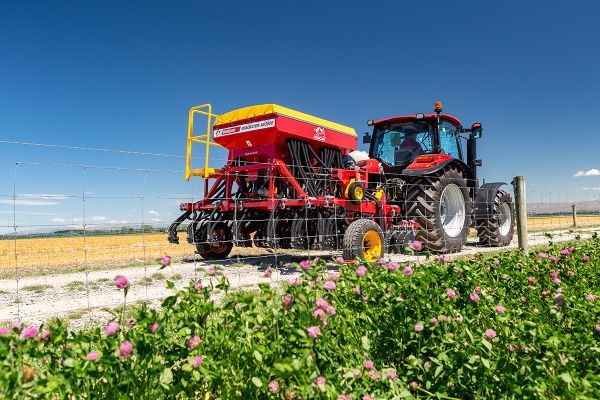 Red Tractor with Attached Sawing Machine in Action — Thompson's Farm Gear In Wauchope, NSW