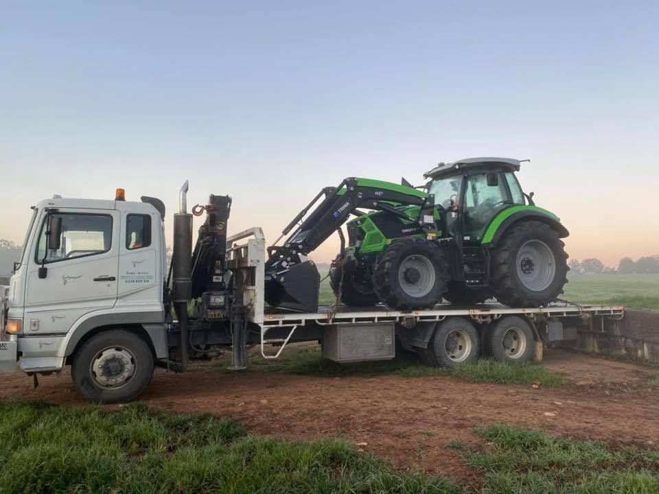 Tractor Transported on a White Trailer Truck — Thompson's Farm Gear In Kempsey, NSW