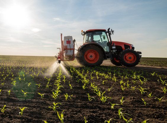 Tractor Spraying Fertiliser on the Farm — Thompson's Farm Gear In Kempsey, NSW