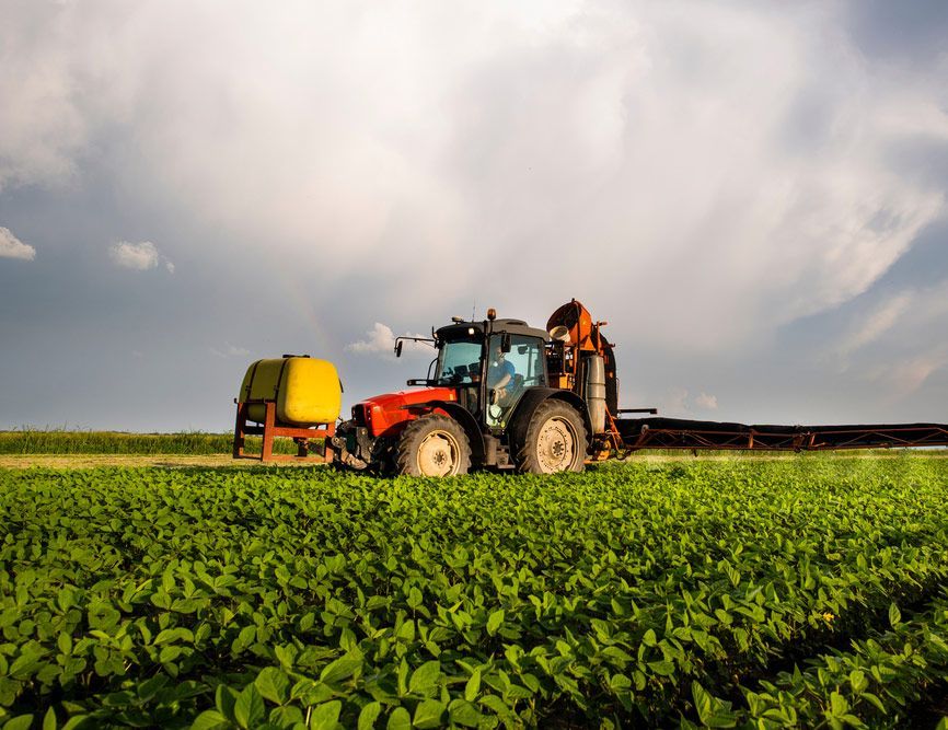 Farm Tractor Applying Fertilizer in Action — Thompson's Farm Gear In Wauchope, NSW