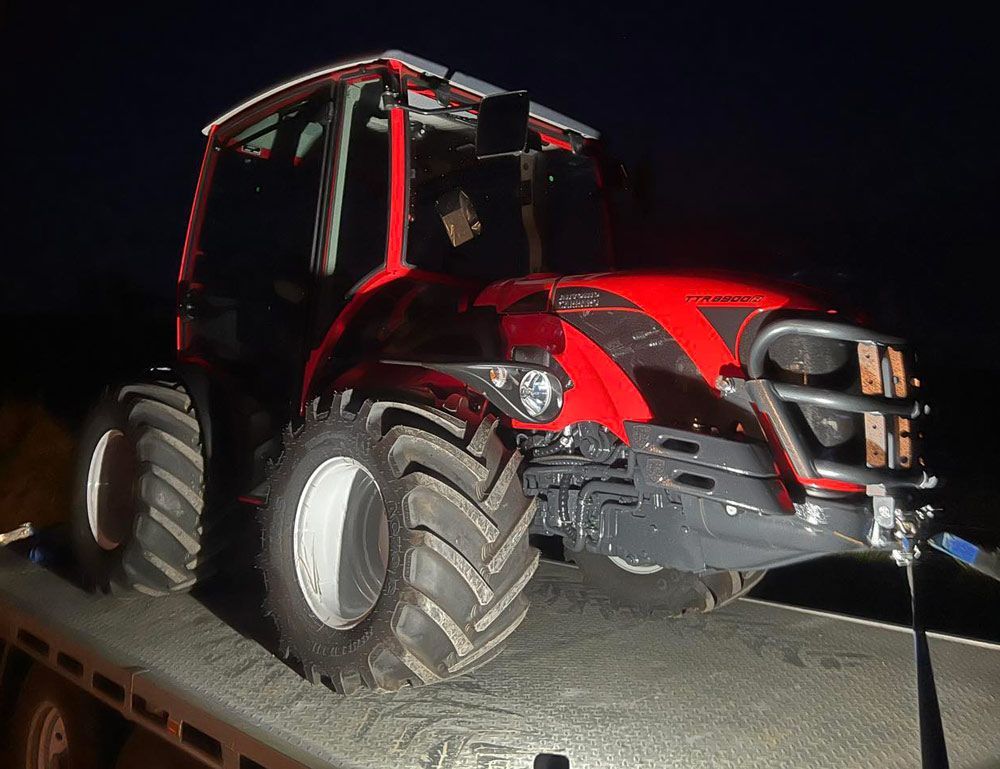 Red Tractor Illuminated at Night with Flashing Lights — Thompson's Farm Gear In Kempsey, NSW