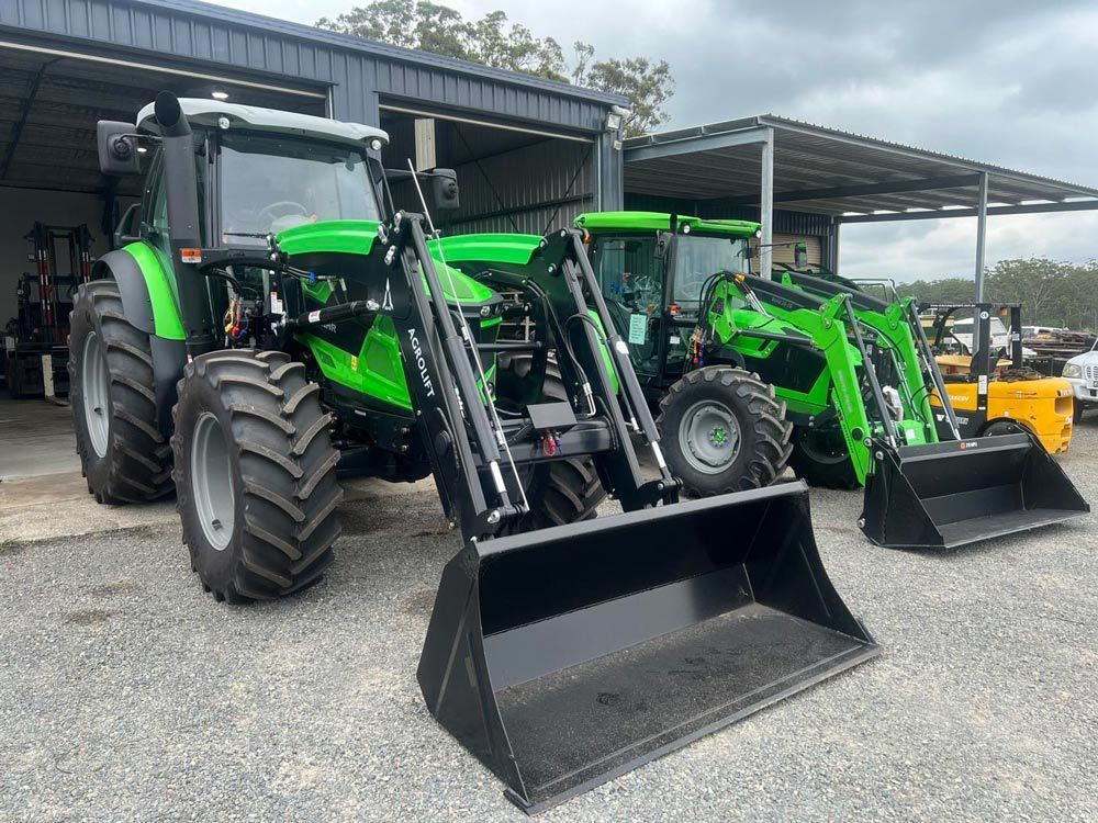 Man Loading Deutz Fahr onto Trailer Truck at Thompson's Farm — Thompson's Farm Gear In Wauchope, NSW